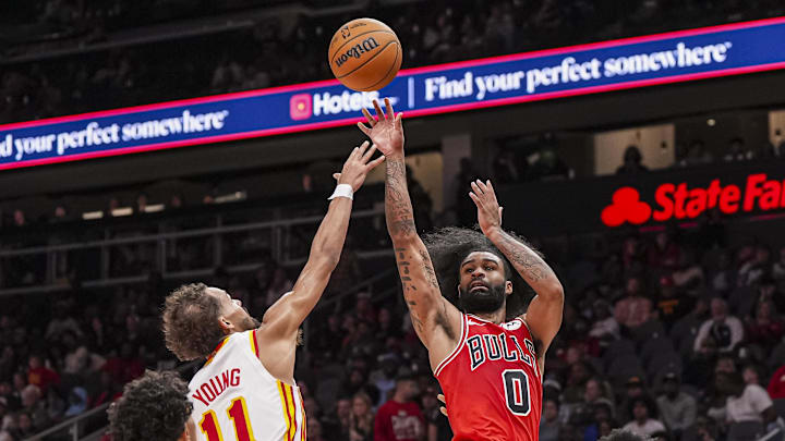 Nov 9, 2024; Atlanta, Georgia, USA; Chicago Bulls guard Coby White (0) shoots over Atlanta Hawks guard Trae Young (11) during the second half at State Farm Arena. Mandatory Credit: Dale Zanine-Imagn Images