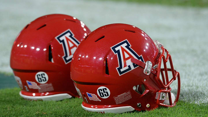 Sep 3, 2016; Glendale, AZ, USA; Stickers on the helmets of Arizona Wildcats platers depict depict the number 65 for deceased player Zach Hemmila (not pictured) prior to the game against the Brigham Young Cougars at University of Phoenix Stadium. Mandatory Credit: Joe Camporeale-Imagn Images