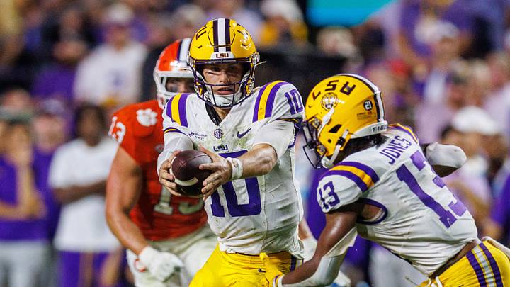 Sep 5, 2026; Baton Rouge, Louisiana, USA; LSU Tigers quarterback Sam Leavitt (10) hands off to running back Dilin Jones (13) against Clemson Tigers during the first half at Tiger Stadium. Mandatory Credit: Stephen Lew-Imagn Images Sep 5, 2026; Baton Rouge, Louisiana, USA; LSU Tigers quarterback Sam Leavitt (10) hands off to running back Dilin Jones (13) against Clemson Tigers during the first half at Tiger Stadium. Mandatory Credit: Stephen Lew-Imagn Images
