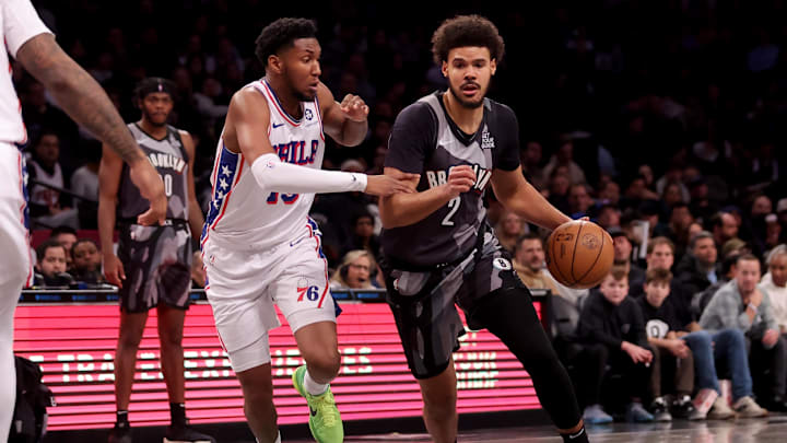 Feb 12, 2025; Brooklyn, New York, USA; Brooklyn Nets forward Cameron Johnson (2) controls the ball against Philadelphia 76ers forward Justin Edwards (19) during the first quarter at Barclays Center. Mandatory Credit: Brad Penner-Imagn Images