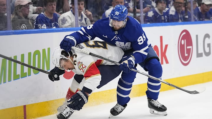 May 18, 2025; Toronto, Ontario, CAN; Toronto Maple Leafs defenceman Oliver Ekman-Larsson (95) checks Florida Panthers forward Brad Marchand (63) during the second period of game seven of the second round of the 2025 Stanley Cup Playoffs at Scotiabank Arena. Mandatory Credit: John E. Sokolowski-Imagn Images