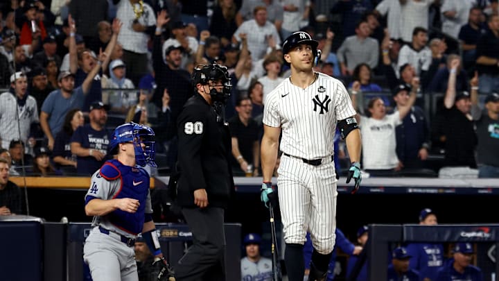Oct 30, 2024; New York, New York, USA; New York Yankees designated hitter Giancarlo Stanton (27) reacts after hitting a home run during the third inning against the Los Angeles Dodgers in game five of the 2024 MLB World Series at Yankee Stadium. Mandatory Credit: Vincent Carchietta-Imagn Images