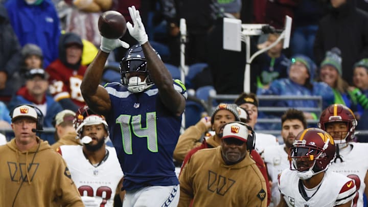 Nov 12, 2023; Seattle, Washington, USA; Seattle Seahawks wide receiver DK Metcalf (14) catches a pass against Washington Commanders cornerback Kendall Fuller (29) during the third quarter at Lumen Field. Mandatory Credit: Joe Nicholson-Imagn Images