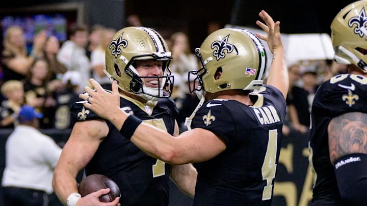 Nov 17, 2024; New Orleans, Louisiana, USA; New Orleans Saints tight end Taysom Hill (7) celebrates a touchdown during the fourth quarter against the Cleveland Browns with New Orleans Saints quarterback Derek Carr (4) at Caesars Superdome. Mandatory Credit: Matthew Hinton-Imagn Images