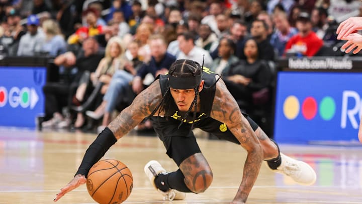 Feb 27, 2024; Atlanta, Georgia, USA; Utah Jazz guard Jordan Clarkson (00) reaches for a loose ball