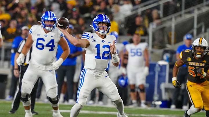 BYU quarterback Jake Retzlaff (12) throws a touchdown pass against the Wyoming Cowboys. Mandatory Credit: Troy Babbitt-Imagn Images