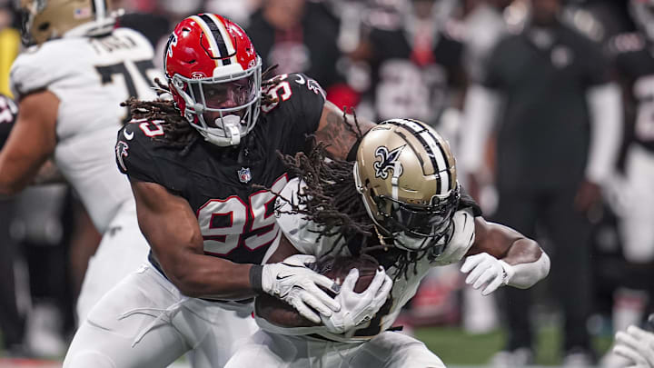 Sep 29, 2024; Atlanta, Georgia, USA; Atlanta Falcons defensive tackle Ta'Quon Graham (95) tackles New Orleans Saints running back Alvin Kamara (41) at Mercedes-Benz Stadium. Sep 29, 2024; Atlanta, Georgia, USA; Atlanta Falcons defensive tackle Ta'Quon Graham (95) tackles New Orleans Saints running back Alvin Kamara (41) at Mercedes-Benz Stadium.