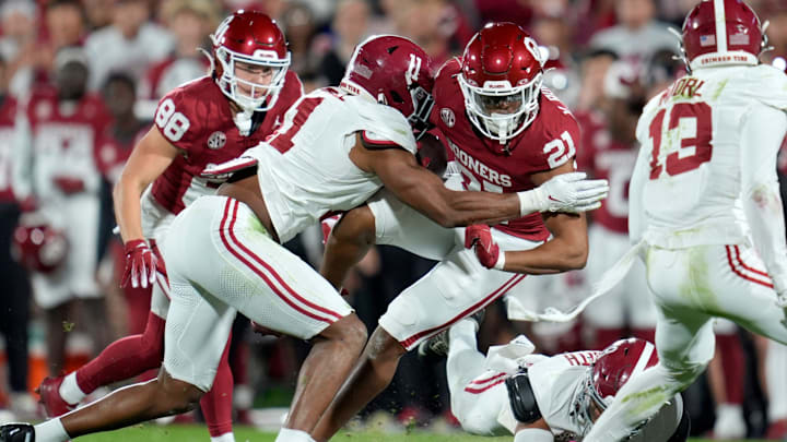 Oklahoma Sooners running back Xavier Robinson (21) is brought down by Alabama Crimson Tide linebacker Jihaad Campbell (11) during a college football game between the University of Oklahoma Sooners (OU) and the Alabama Crimson Tide at Gaylord Family - Oklahoma Memorial Stadium in Norman, Okla., Saturday, Nov. 23, 2024.