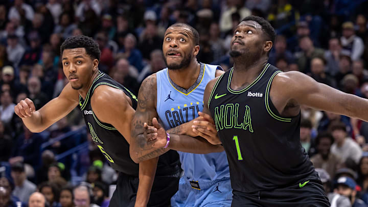 Dec 26, 2023; New Orleans, Louisiana, USA; New Orleans Pelicans forward Zion Williamson (1) and New Orleans Pelicans guard Trey Murphy III (25) hold back the Memphis Grizzlies on a free throw attempt during the second half at the Smoothie King Center. Mandatory Credit: Stephen Lew-Imagn Images