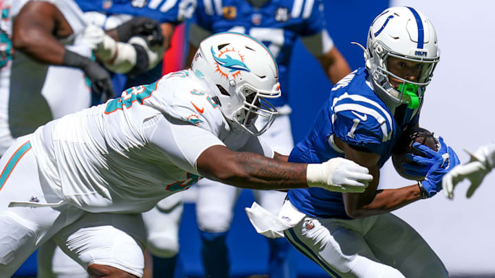 Miami Dolphins defensive tackle Kenneth Grant (90) attempts to take down Indianapolis Colts wide receiver Josh Downs (1) during the first half of a game Sunday, Sept. 7, 2025, at Lucas Oil Stadium in Indianapolis.