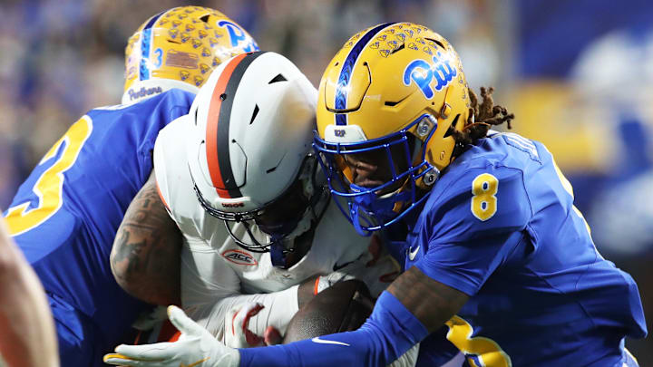 Nov 9, 2024; Pittsburgh, Pennsylvania, USA; Pittsburgh Panthers defensive back Tamon Lynum (8) intercepts a pass intended for Virginia Cavaliers wide receiver Malachi Fields (middle) during the first quarter at Acrisure Stadium. Mandatory Credit: Charles LeClaire-Imagn Images Nov 9, 2024; Pittsburgh, Pennsylvania, USA; Pittsburgh Panthers defensive back Tamon Lynum (8) intercepts a pass intended for Virginia Cavaliers wide receiver Malachi Fields (middle) during the first quarter at Acrisure Stadium. Mandatory Credit: Charles LeClaire-Imagn Images