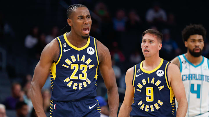 Oct 5, 2022; Charlotte, North Carolina, USA; Indiana Pacers forward Aaron Nesmith (23) and guard T.J. McConnell (9) react in the first half of an NBA preseason game against the Charlotte Hornets at Spectrum Center. Mandatory Credit: Nell Redmond-Imagn Images