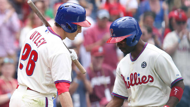 May 18, 2014; Philadelphia, PA, USA; Philadelphia Phillies shortstop Jimmy Rollins (11) celebrates with second baseman Chase Utley (26) after hitting a home run in the first inning against the Cincinnati Reds at Citizens Bank Park. Mandatory Credit: Bill Streicher-Imagn Images