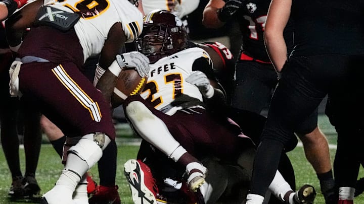 CoffeeÕs Tyrese Woodgett (27) drives in foe a touchdown during a GHSA 1st round high school football playoff game against Coffee in Hoschton, Ga., on Friday, Nov. 15, 2024.