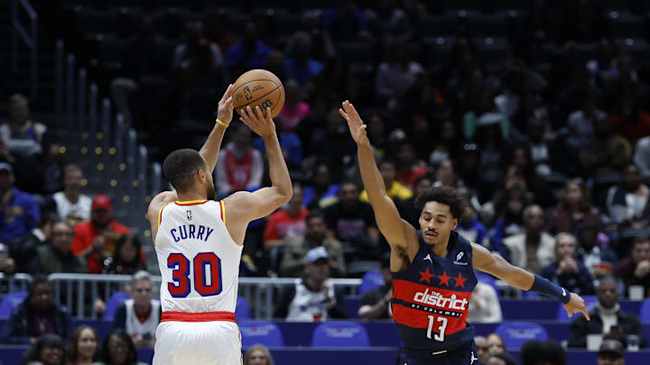Nov 4, 2024; Washington, District of Columbia, USA; Golden State Warriors guard Stephen Curry (30) shoots the ball over Washington Wizards guard Jordan Poole (13) in the first half at Capital One Arena. Mandatory Credit: Geoff Burke-Imagn Images