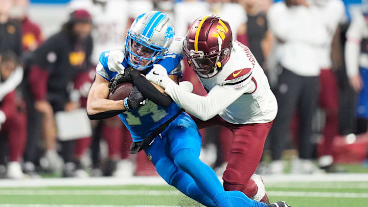 Detroit Lions wideout Amon-Ra St. Brown (14) is brought down by Washington Commanders cornerback Noah Igbinoghene (1) Detroit Lions wideout Amon-Ra St. Brown (14) is brought down by Washington Commanders cornerback Noah Igbinoghene (1)