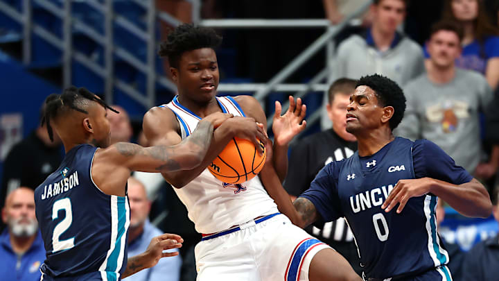 Kansas basketball guard Rakease Passmore (4) fights for the ball