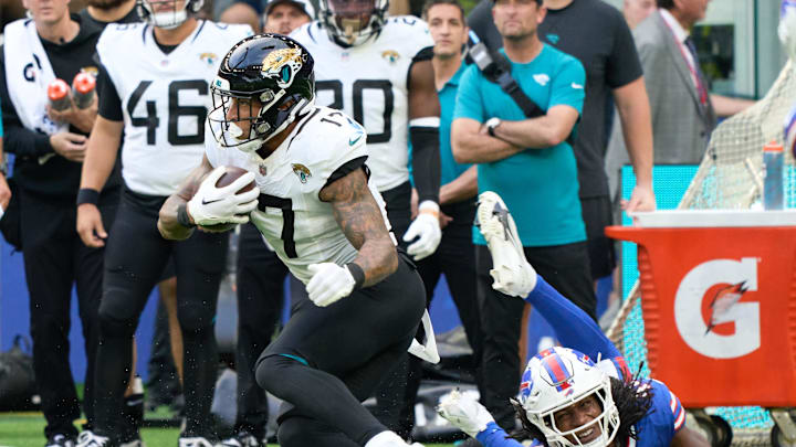 Oct 8, 2023; London, United Kingdom;  Jacksonville Jaguars tight end Evan Engram (17) skips past Buffalo Bills linebacker Dorian Williams (42) during the first half of an NFL International Series game at Tottenham Hotspur Stadium. Mandatory Credit: Peter van den Berg-Imagn Images