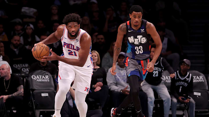 Nov 19, 2023; Brooklyn, New York, USA; Philadelphia 76ers center Joel Embiid (21) brings the ball up court against Brooklyn Nets center Nic Claxton (33) during the first quarter at Barclays Center. Mandatory Credit: Brad Penner-Imagn Images