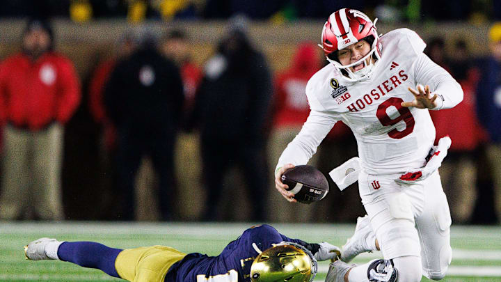 Notre Dame defensive lineman Loghan Thomas (10) tackles Indiana defensive back Jamier Johnson (9) during the first round of the College Football Playoff between Notre Dame and Indiana at Notre Dame Stadium on Friday, Dec. 20, 2024, in South Bend.