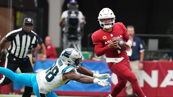 Arizona Cardinals quarterback Kyler Murray (1) scrambles away from Carolina Panthers linebacker D.J. Wonnum (98) at State Farm Stadium on Sept 14, 2025. Arizona Cardinals quarterback Kyler Murray (1) scrambles away from Carolina Panthers linebacker D.J. Wonnum (98) at State Farm Stadium on Sept 14, 2025.