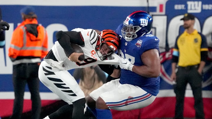 Oct 13, 2024; East Rutherford, New Jersey, USA;  Cincinnati Bengals quarterback Joe Burrow (9) is sacked by New York Giants defensive tackle Dexter Lawrence II (97) in the 3rd quarter at MetLife Stadium. Mandatory Credit: Robert Deutsch-Imagn Images