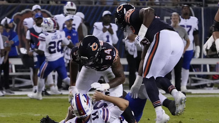 Aug 17, 2025; Chicago, Illinois, USA; Chicago Bears defensive end Austin Booker (94) sacks Buffalo Bills quarterback Mike White (14) during the first half at Soldier Field. Mandatory Credit: David Banks-Imagn Images