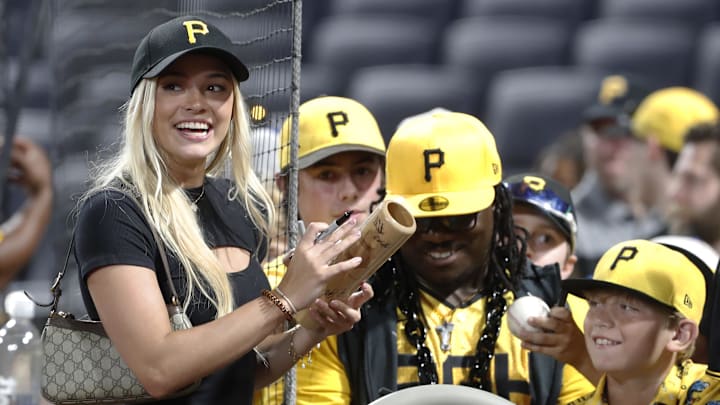 Jun 5, 2024; Pittsburgh, Pennsylvania, USA;  Former Louisiana State University gymnast Olivia Dunne (left) signs autographs after the Pittsburgh Pirates defeated the Los Angeles Dodgers at PNC Park. Pittsburgh won 10-6. Mandatory Credit: Charles LeClaire-Imagn Images
