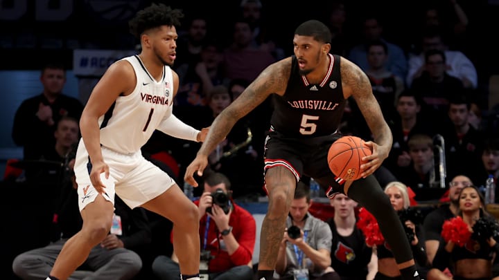 Mar 9, 2022; Brooklyn, NY, USA; Louisville Cardinals forward Malik Williams (5) controls the ball against Virginia Cavaliers forward Jayden Gardner (1) during the second half at Barclays Center. Mandatory Credit: Brad Penner-Imagn Images