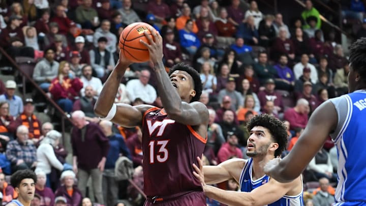 Jan 31, 2026; Blacksburg, Virginia, USA;  Virginia Tech Hokies forward Amani Hansberry (13) looks to shoot, defended by Duke Blue Devils forward Cameron Boozer (12)during the second half at Cassell Coliseum. Mandatory Credit: Brian Bishop-Imagn Images