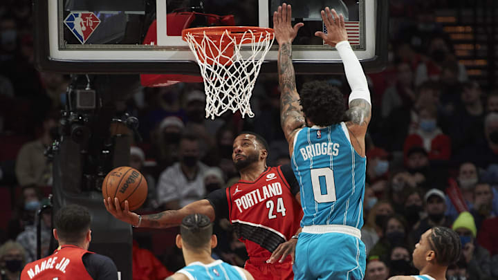 Dec 17, 2021; Portland, Oregon, USA; Charlotte Hornets forward Miles Bridges (0) defends Portland Trail Blazers forward Norman Powell (24) during the second half at Moda Center. The Portland Trail Blazers won the game 125-116. Mandatory Credit: Troy Wayrynen-Imagn Images Dec 17, 2021; Portland, Oregon, USA; Charlotte Hornets forward Miles Bridges (0) defends Portland Trail Blazers forward Norman Powell (24) during the second half at Moda Center. The Portland Trail Blazers won the game 125-116. Mandatory Credit: Troy Wayrynen-Imagn Images