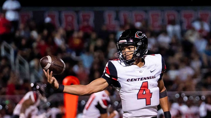Centennial Huskies Quarterback Husan Longstreet (4) catches the ball at Liberty High School on Sept. 21, 2024, in Peoria. Centennial Huskies Quarterback Husan Longstreet (4) catches the ball at Liberty High School on Sept. 21, 2024, in Peoria.