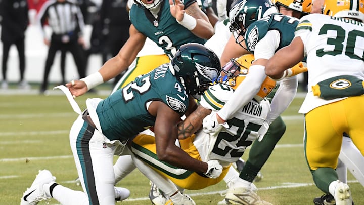 Jan 12, 2025; Philadelphia, Pennsylvania, USA; Philadelphia Eagles linebacker Oren Burks (42) causes a fumble on Green Bay Packers cornerback Keisean Nixon (25) for the opening kick off during the first half in an NFC wild card game at Lincoln Financial Field.