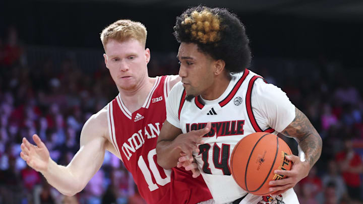 Nov 27, 2024; Paradise Island, Bahamas, BHS; Louisville Cardinals guard Chucky Hepburn (24) drives to the basket as Indiana Hoosiers forward Luke Goode (10) defends during the first half at the Atlantis Resort. 