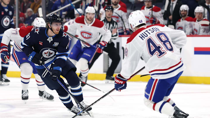 Feb 4, 2026; Winnipeg, Manitoba, CAN; Winnipeg Jets left wing Kyle Connor (81) skates up the ice to Montreal Canadiens defenseman Lane Hutson (48) in the second period at Canada Life Centre. Mandatory Credit: James Carey Lauder-Imagn Images