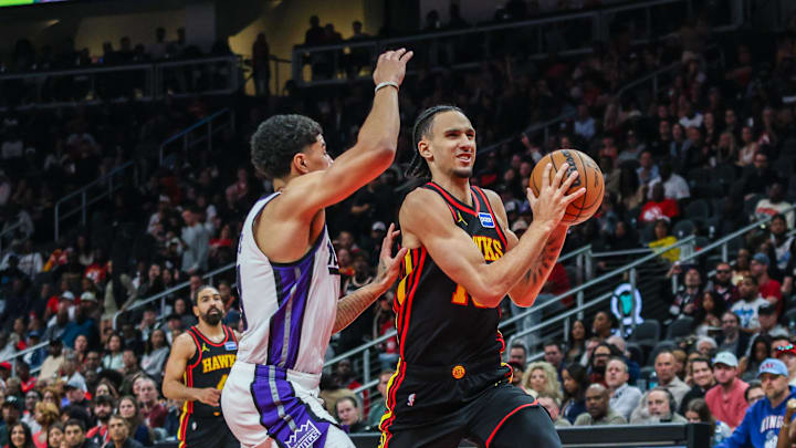 Mar 28, 2026; Atlanta, Georgia, USA; Atlanta Hawks forward Zaccharie Risacher (10) drives the ball towards the goal against Sacramento Kings guard Killian Hayes (3) during the fourth quarter at State Farm Arena. Mandatory Credit: Jordan Godfree-Imagn Images