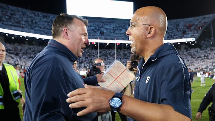 Sep 28, 2024; University Park, Pennsylvania, USA; Penn State Nittany Lions head coach James Franklin (right) shakes hands with Illinois Fighting Illini head coach Bret Bielema following a game at Beaver Stadium. Penn State defeated Illinois 21-7. Mandatory Credit: Matthew O'Haren-Imagn Images