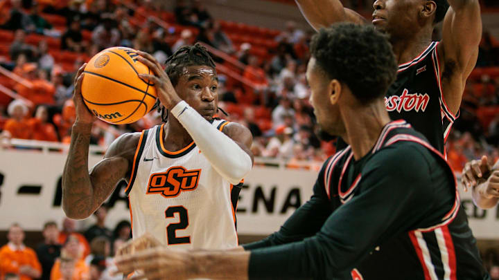 Dec 30, 2024; Stillwater, Oklahoma, USA; Oklahoma State Cowboys guard Arturo Dean (2) looks to pass during the first half against the Houston Cougars at Gallagher-Iba Arena. Mandatory Credit: William Purnell-Imagn Images