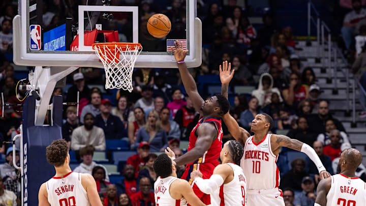 Dec 23, 2023; New Orleans, Louisiana, USA;  New Orleans Pelicans forward Zion Williamson (1) drives to the basket against Houston Rockets forward Jabari Smith Jr. (10) and forward Dillon Brooks (9) during the second half at Smoothie King Center. Mandatory Credit: Stephen Lew-Imagn Images