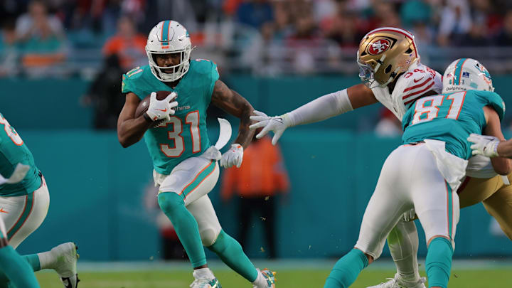 Miami Dolphins running back Raheem Mostert (31) runs with the football past San Francisco 49ers defensive end Yetur Gross-Matos (94) during the second quarter at Hard Rock Stadium.