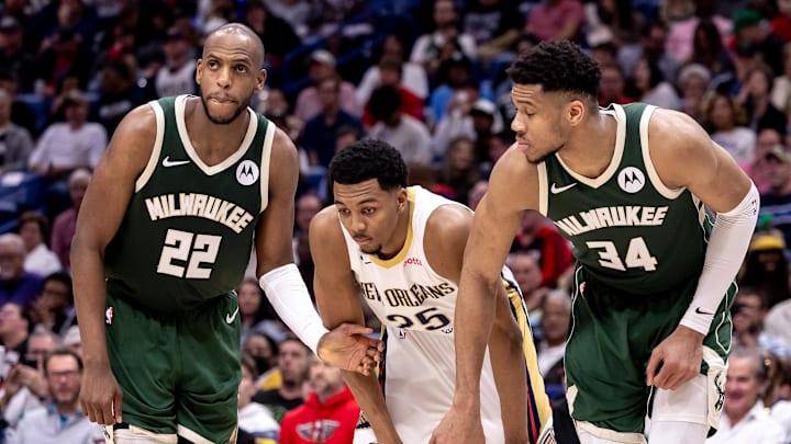 Mar 28, 2024; New Orleans, Louisiana, USA;  Milwaukee Bucks forward Khris Middleton (22) and forward Giannis Antetokounmpo (34) block New Orleans Pelicans guard Trey Murphy III (25) on a free throw attempt during the second half at Smoothie King Center. Mandatory Credit: Stephen Lew-Imagn Images