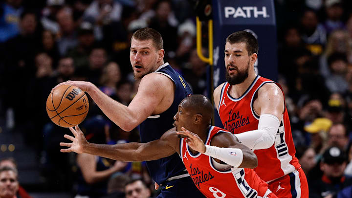 Dec 13, 2024; Denver, Colorado, USA; Los Angeles Clippers guard Kris Dunn (8) attempts to steal the ball away from Denver Nuggets center Nikola Jokic (15) as center Ivica Zubac (40) defends in the second quarter at Ball Arena. Mandatory Credit: Isaiah J. Downing-Imagn Images Dec 13, 2024; Denver, Colorado, USA; Los Angeles Clippers guard Kris Dunn (8) attempts to steal the ball away from Denver Nuggets center Nikola Jokic (15) as center Ivica Zubac (40) defends in the second quarter at Ball Arena. Mandatory Credit: Isaiah J. Downing-Imagn Images