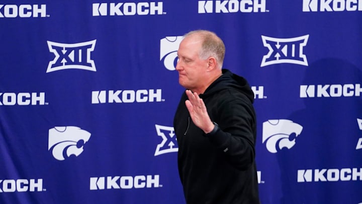 Kansas State football head coach Chris Klieman waves his hand after standing up at a press announcement where he shared his thoughts on his retirement. Kansas State football head coach Chris Klieman waves his hand after standing up at a press announcement where he shared his thoughts on his retirement.