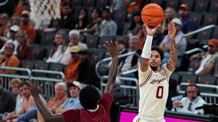 Nov 18, 2025; Austin, Texas, USA; Texas Longhorns guard Jordan Pope (0) shoots a three point basket against Rider Broncs guard Jamir McNeil (5) during the second half at Moody Center. Mandatory Credit: Dustin Safranek-Imagn Images