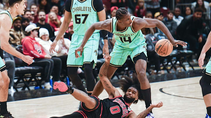 Dec 13, 2024; Chicago, Illinois, USA; Chicago Bulls guard Coby White (0) fights for the ball with Charlotte Hornets forward Moussa Diabate (14) during the second half at the United Center. Mandatory Credit: Matt Marton-Imagn Images