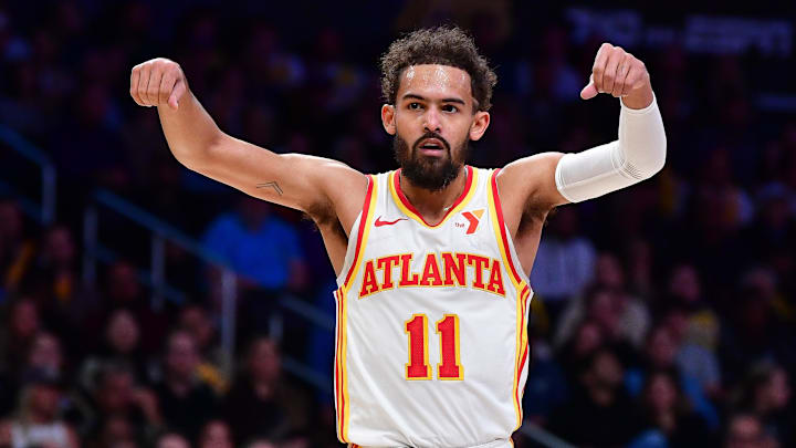 Jan 3, 2025; Los Angeles, California, USA; Atlanta Hawks guard Trae Young (11) reacts after forward Jalen Johnson (1) scores a basket and draws the foul against the Los Angeles Lakers during the first half at Crypto.com Arena. Mandatory Credit: Gary A. Vasquez-Imagn Images