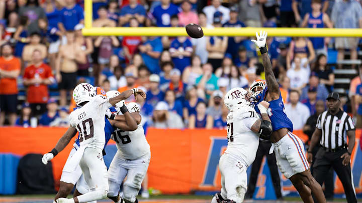 Sep 14, 2024; Gainesville, Florida, USA; Texas A&M Aggies quarterback Marcel Reed (10) throws over the hand of Florida Gators defensive end George Gumbs Jr. (34) during the first half at Ben Hill Griffin Stadium. Mandatory Credit: Matt Pendleton-Imagn Images