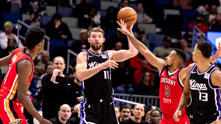 Dec 12, 2024; New Orleans, Louisiana, USA;  Sacramento Kings forward Domantas Sabonis (11) passes to forward Keegan Murray (13) against New Orleans Pelicans center Yves Missi (21) and guard CJ McCollum (3) during the second half at Smoothie King Center. Mandatory Credit: Stephen Lew-Imagn Images