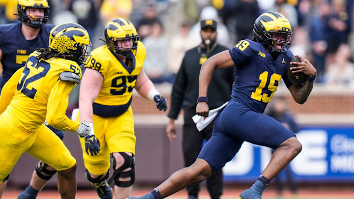 Team Blue quarterback Bryce Underwood (19) runs against Team Maize during the second half of the spring game at Michigan Stadium in Ann Arbor on Saturday, April 19, 2025.