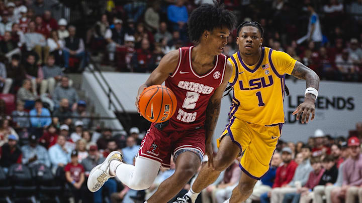 Jan 25, 2025; Tuscaloosa, Alabama, USA; Alabama Crimson Tide guard Aden Holloway (2) controls the ball against LSU Tigers guard Jordan Sears (1) during the first half at Coleman Coliseum. Mandatory Credit: Will McLelland-Imagn Images